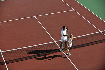 Image showing happy young couple play tennis game outdoor