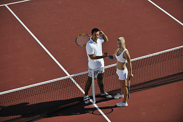 Image showing happy young couple play tennis game outdoor