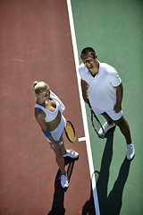 Image showing happy young couple play tennis game outdoor