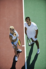 Image showing happy young couple play tennis game outdoor