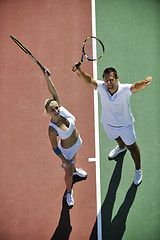 Image showing happy young couple play tennis game outdoor