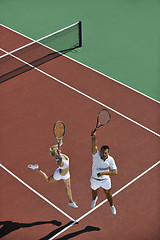 Image showing happy young couple play tennis game outdoor