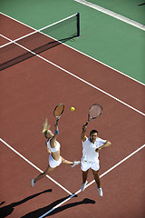 Image showing happy young couple play tennis game outdoor