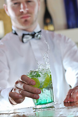 Image showing pro barman prepare coctail drink on party