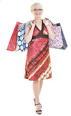 Image showing happy young adult women  shopping with colored bags