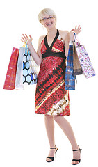 Image showing happy young adult women  shopping with colored bags