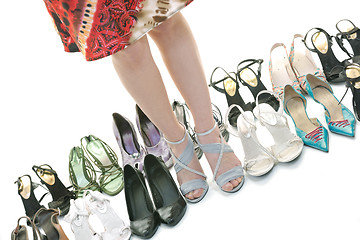 Image showing pretty young woman with buying shoes addiction, isolated on whit