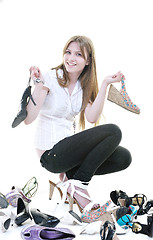 Image showing pretty young woman with buying shoes addiction, isolated on whit