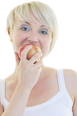 Image showing happy  young  woman eat green apple isolated  on white