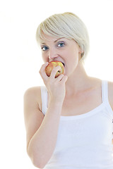 Image showing happy  young  woman eat green apple isolated  on white