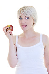 Image showing happy  young  woman eat green apple isolated  on white