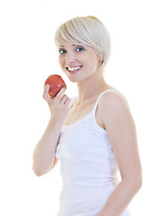 Image showing happy  young  woman eat green apple isolated  on white