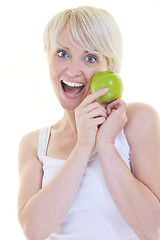 Image showing happy  young  woman eat green apple isolated  on white