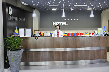 Image showing smiling businesswoman at the reception desk