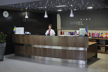 Image showing smiling businesswoman at the reception desk