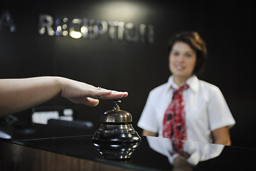 Image showing smiling businesswoman at the reception desk