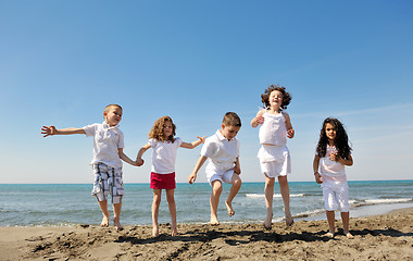 Image showing happy child group playing  on beach