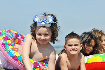 Image showing child group have fun and play with beach toys