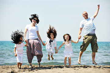 Image showing happy young family have fun on beach