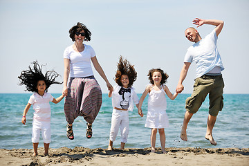 Image showing happy young family have fun on beach