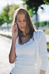 Image showing young woman talk by cellphone on street