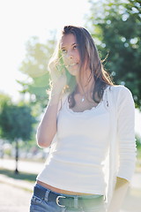 Image showing young woman talk by cellphone on street