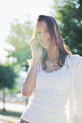 Image showing young woman talk by cellphone on street