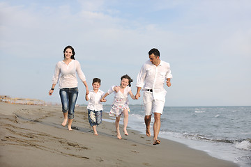 Image showing happy young family have fun on beach