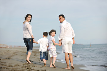 Image showing happy young family have fun on beach