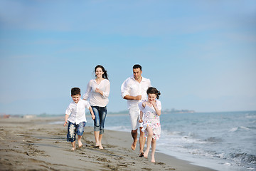 Image showing happy young family have fun on beach