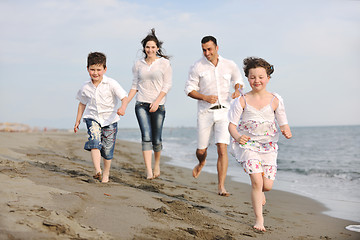 Image showing happy young family have fun on beach