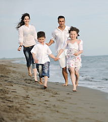 Image showing happy young family have fun on beach