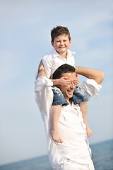 Image showing happy father and son have fun and enjoy time on beach