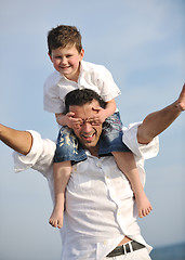 Image showing happy father and son have fun and enjoy time on beach