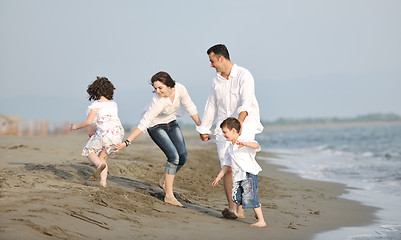 Image showing happy young family have fun on beach