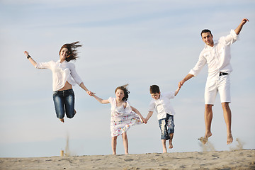 Image showing happy young family have fun on beach