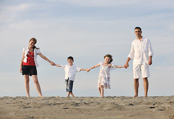 Image showing happy young family have fun on beach