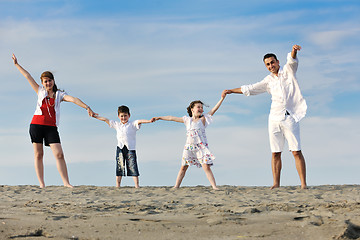 Image showing happy young family have fun on beach