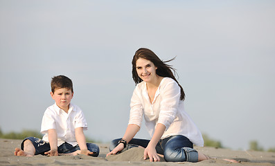 Image showing mom and son relaxing on beach