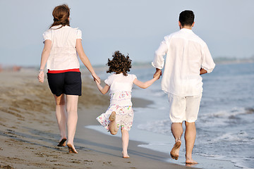 Image showing happy young family have fun on beach