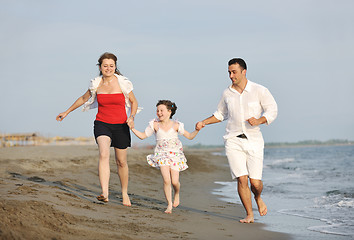 Image showing happy young family have fun on beach