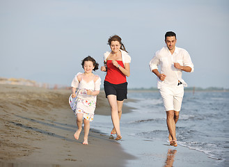 Image showing happy young family have fun on beach