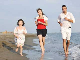 Image showing happy young family have fun on beach