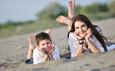 Image showing mom and son relaxing on beach