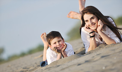 Image showing mom and son relaxing on beach