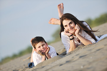 Image showing mom and son relaxing on beach