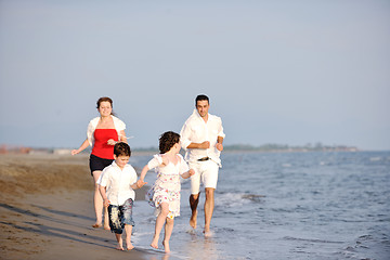 Image showing happy young family have fun on beach