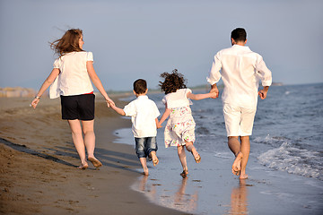 Image showing happy young family have fun on beach