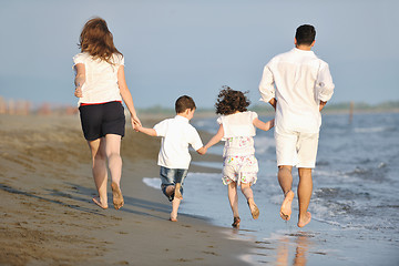 Image showing happy young family have fun on beach