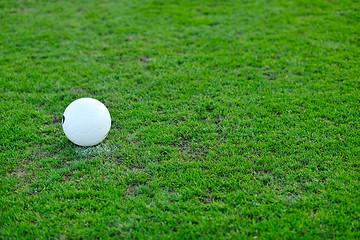 Image showing Soccer ball on grass at goal and stadium in background